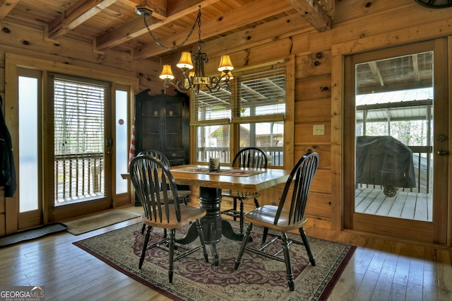dining room with a chandelier, plenty of natural light, and hardwood / wood-style floors