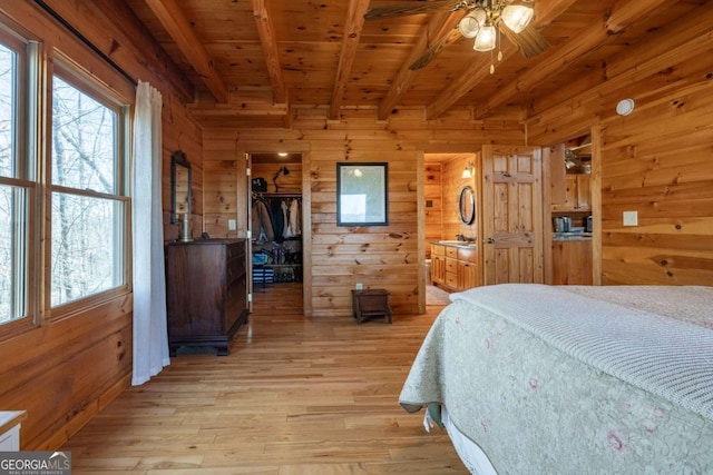 bedroom featuring wood ceiling, light wood-type flooring, multiple windows, and beamed ceiling