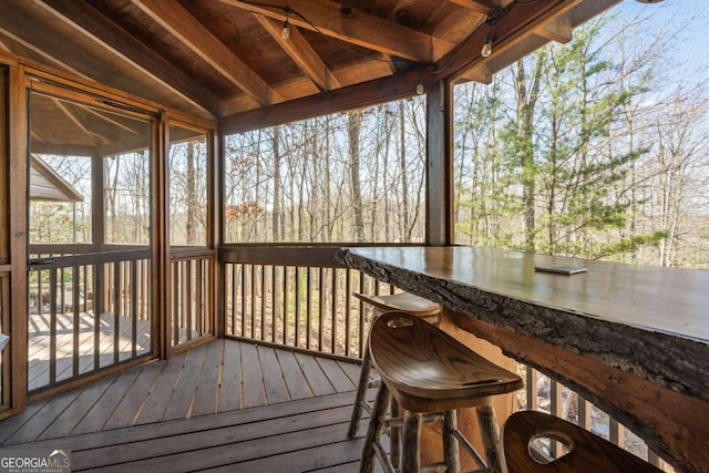 unfurnished sunroom featuring lofted ceiling