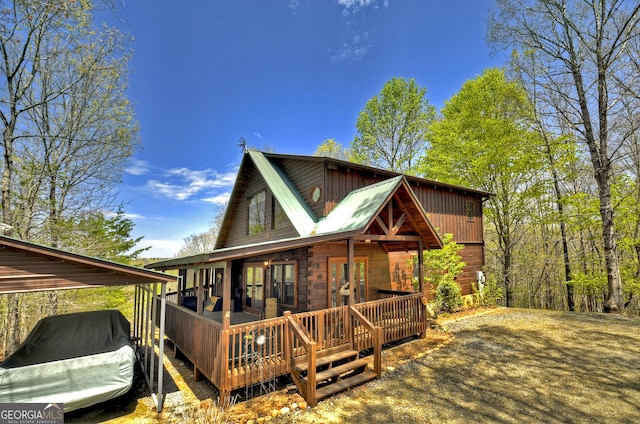exterior space with a carport and a wooden deck