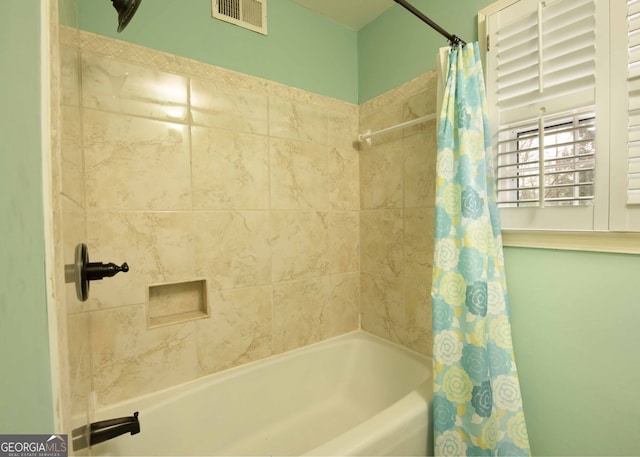 full bathroom featuring visible vents and shower / bath combo with shower curtain