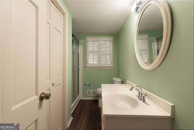 full bathroom featuring visible vents, baseboards, toilet, a stall shower, and vanity