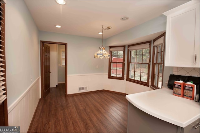 dining room featuring dark wood finished floors, recessed lighting, visible vents, and wainscoting