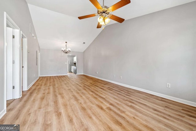 unfurnished living room featuring light wood-type flooring, baseboards, vaulted ceiling, and ceiling fan with notable chandelier