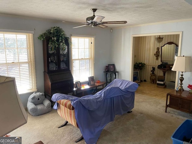 carpeted living room featuring a textured ceiling and ceiling fan