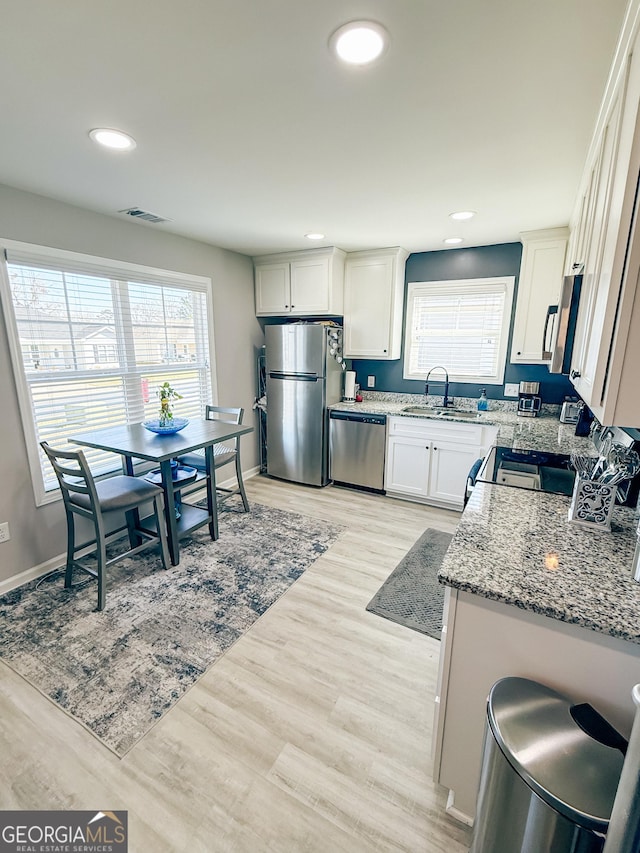 kitchen featuring plenty of natural light, visible vents, appliances with stainless steel finishes, and a sink