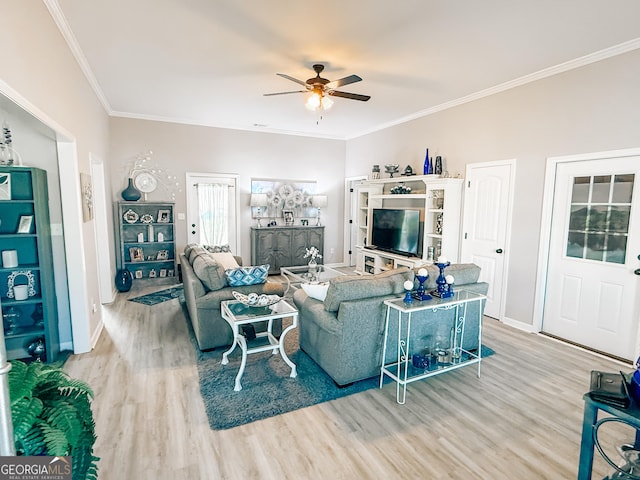 living room with ornamental molding, baseboards, a ceiling fan, and wood finished floors