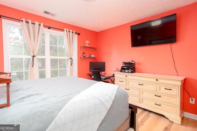 bedroom featuring visible vents and light wood finished floors