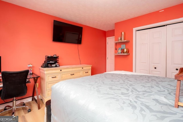 bedroom with a closet and a textured ceiling