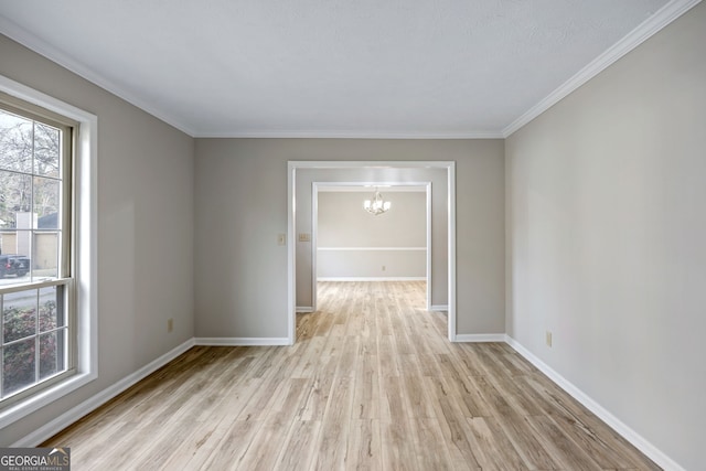 unfurnished room with a chandelier, baseboards, light wood-style floors, and ornamental molding