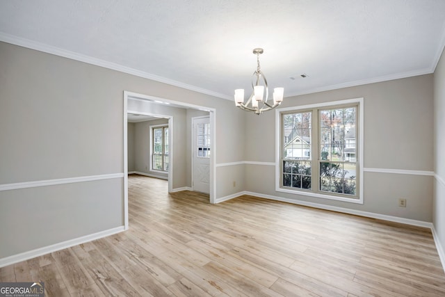 unfurnished dining area featuring visible vents, baseboards, an inviting chandelier, ornamental molding, and light wood-style floors