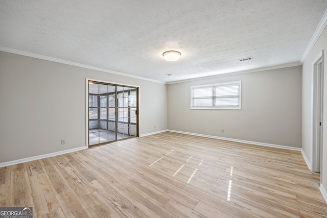 spare room with visible vents, a textured ceiling, light wood-style floors, crown molding, and baseboards