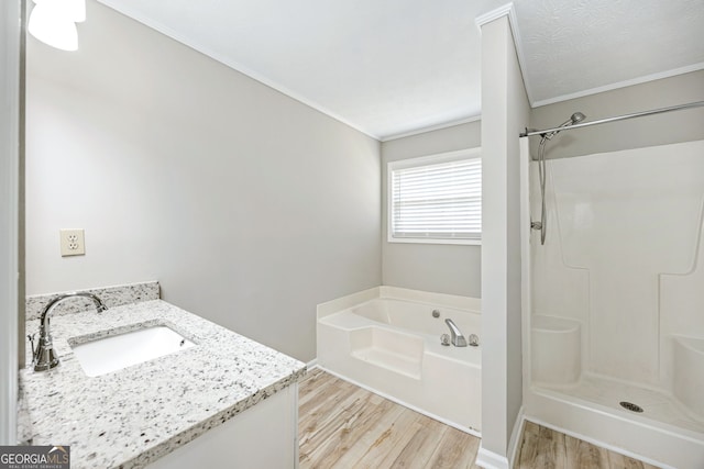 full bath with vanity, a shower, a garden tub, and wood finished floors