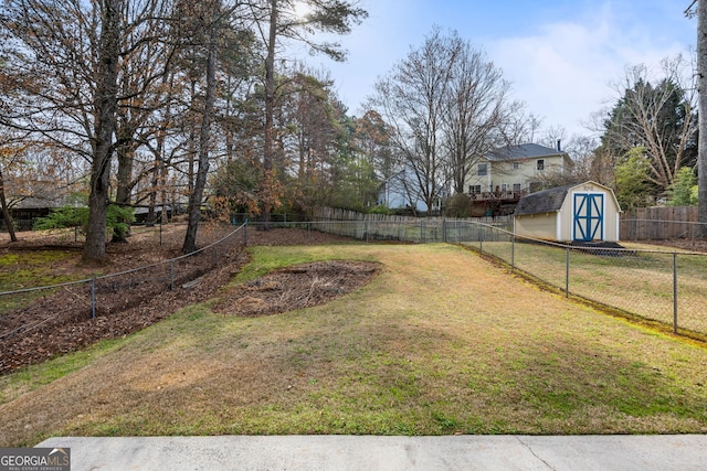 view of yard with a storage unit, a fenced backyard, and an outdoor structure