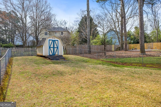 view of yard with an outbuilding, a storage shed, and a fenced backyard