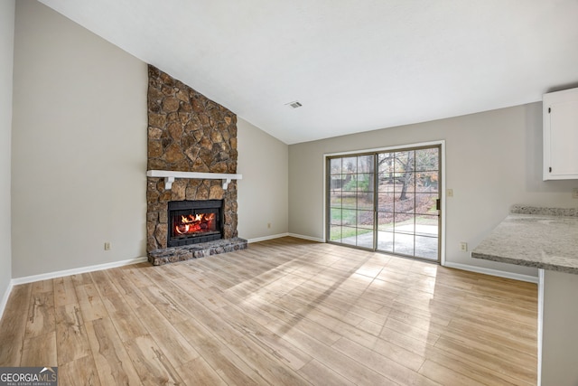 unfurnished living room with visible vents, light wood-style flooring, a fireplace, and baseboards