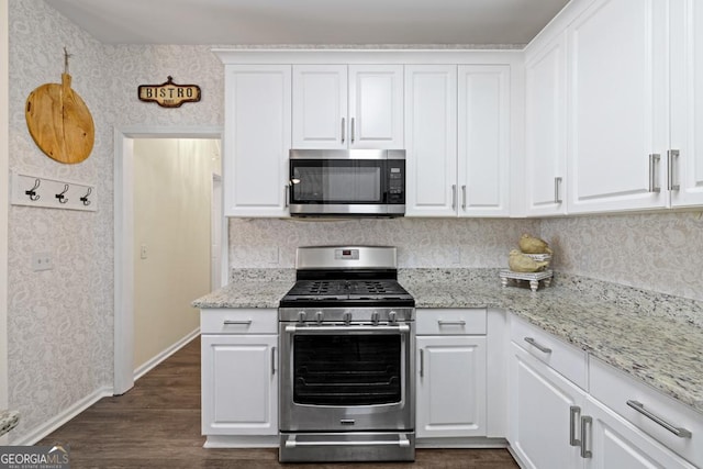 49 Inverness Ct, Hiram, GA 30141 - kitchen featuring appliances with stainless steel finishes, wallpapered walls, baseboards, and white cabinets
