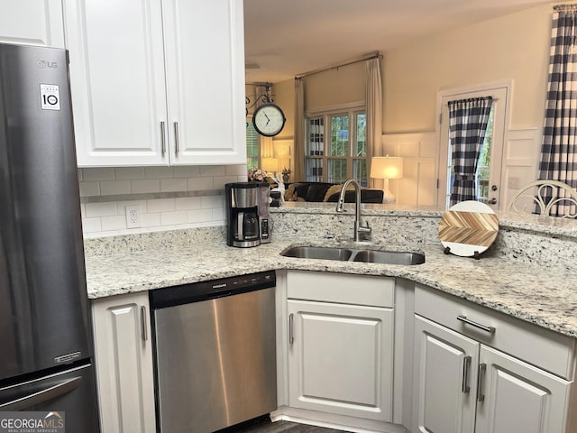 49 Inverness Ct, Hiram, GA 30141 - kitchen with stainless steel appliances, a sink, tasteful backsplash, white cabinets, and light stone countertops