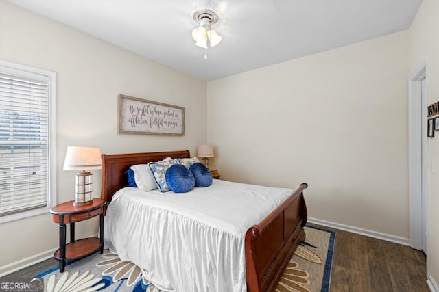 bedroom with baseboards and wood finished floors
