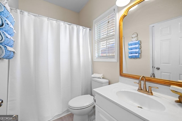bathroom featuring vanity, toilet, and curtained shower