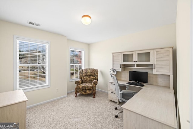 office area featuring baseboards, carpet flooring, and visible vents