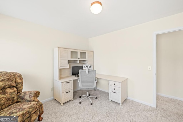 home office featuring baseboards and light carpet