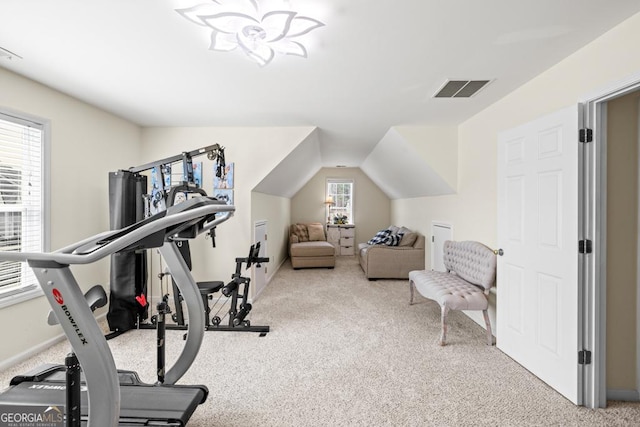 workout area with carpet floors, baseboards, vaulted ceiling, and visible vents