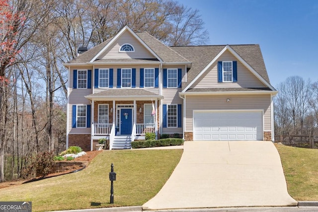 view of front of property with covered porch, driveway, and a front yard