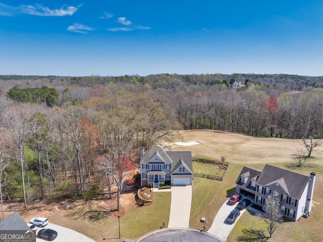 birds eye view of property with a view of trees