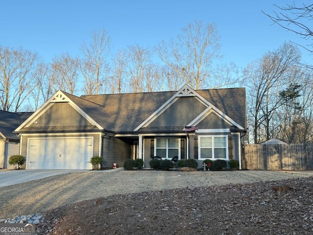 craftsman-style home featuring an attached garage, driveway, and fence