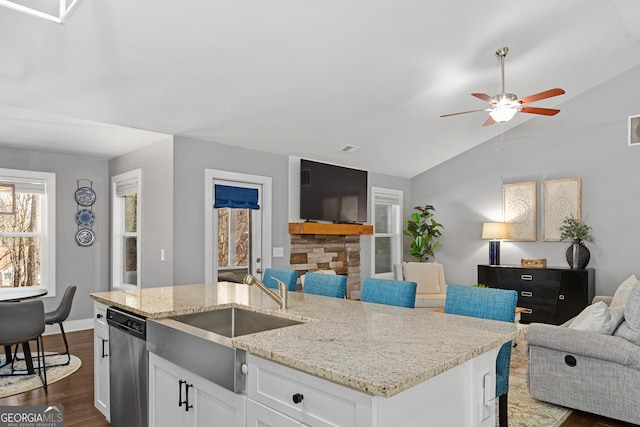 kitchen with a ceiling fan, dark wood-type flooring, white cabinets, dishwasher, and open floor plan