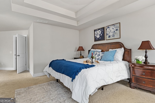 bedroom featuring visible vents, carpet floors, a raised ceiling, and baseboards