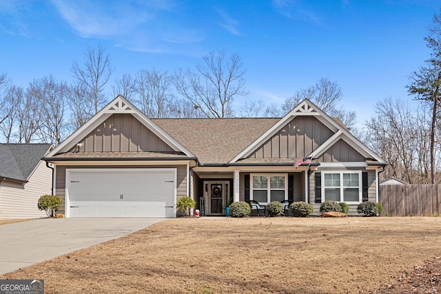 craftsman inspired home with a garage, board and batten siding, concrete driveway, and fence