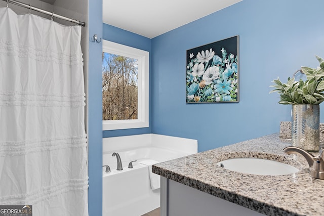 bathroom featuring vanity, a garden tub, and curtained shower