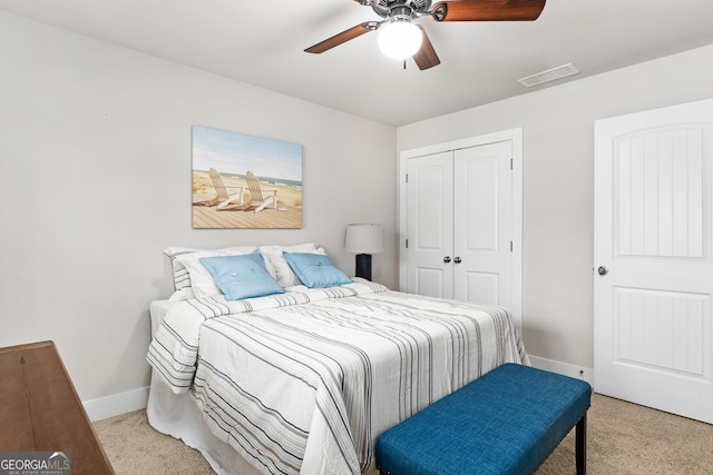 bedroom with visible vents, a closet, carpet flooring, baseboards, and ceiling fan