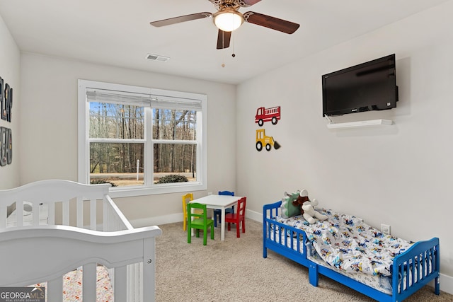 carpeted bedroom featuring visible vents, a ceiling fan, and baseboards