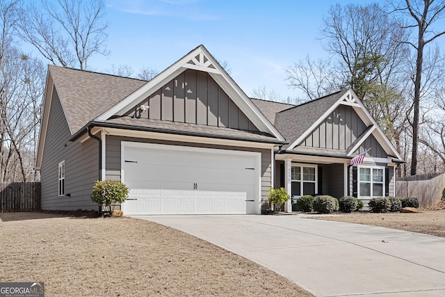 craftsman-style home featuring a garage, fence, board and batten siding, and driveway