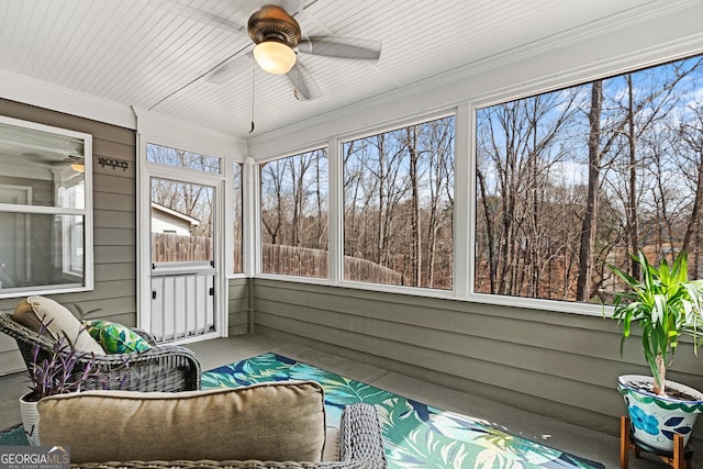 sunroom / solarium with a ceiling fan