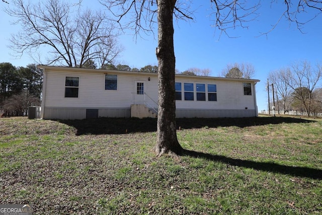 2802 County Road 19, Woodland, AL 36280 - rear view of house featuring entry steps, a lawn, and cooling unit