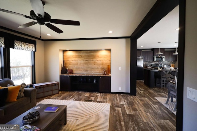 2802 County Road 19, Woodland, AL 36280 - living area featuring dark wood-style floors, a ceiling fan, ornamental molding, bar with sink, and recessed lighting