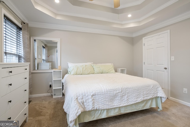 bedroom featuring a raised ceiling, crown molding, baseboards, and carpet floors