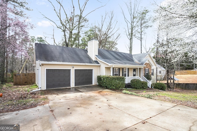 ranch-style home featuring fence, driveway, a porch, a chimney, and a garage