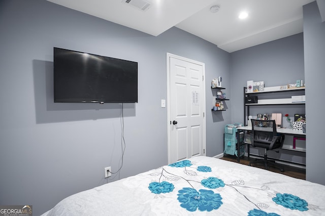 bedroom with visible vents and wood finished floors