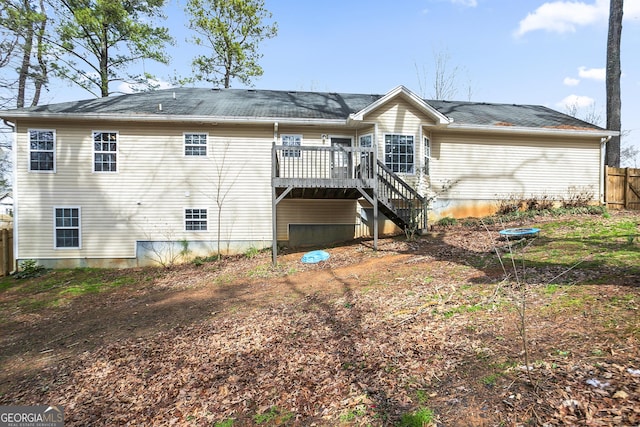 back of house with stairway, a wooden deck, and fence