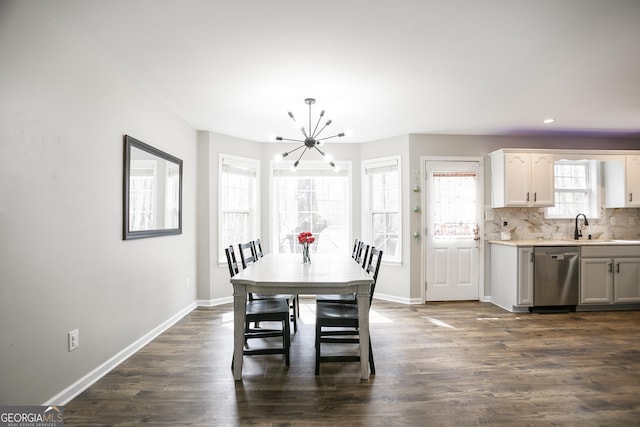 dining room featuring a chandelier, baseboards, and dark wood-style floors