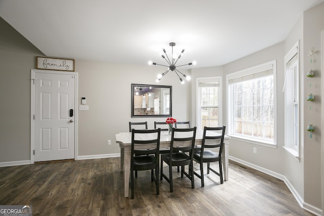 dining room with an inviting chandelier, baseboards, and dark wood-style flooring