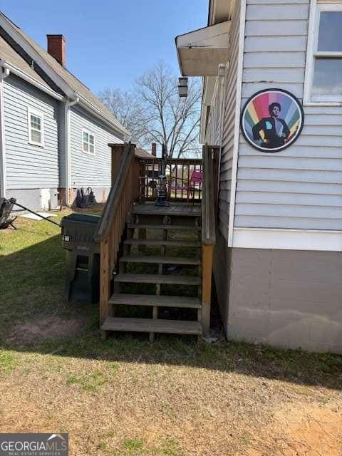 exterior space featuring stairs and a lawn