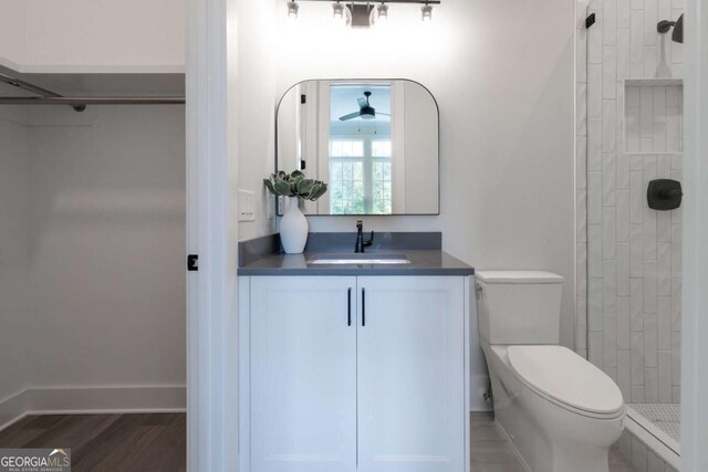 64 Telfair Ct, Acworth, GA 30101 - full bathroom with toilet, wood finished floors, vanity, baseboards, and tiled shower