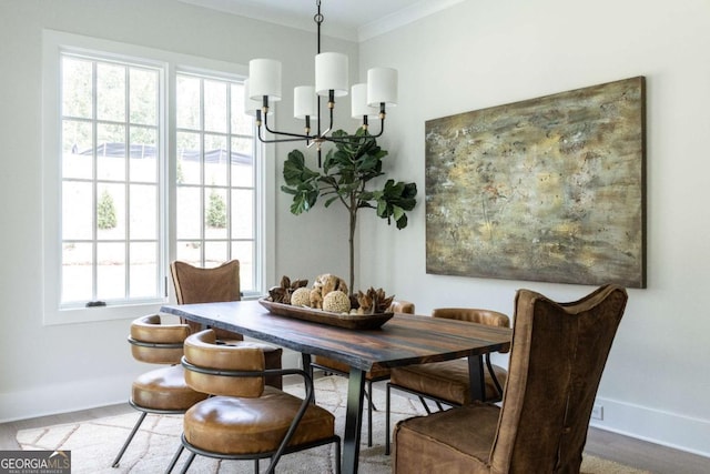 dining room featuring a chandelier, baseboards, and ornamental molding