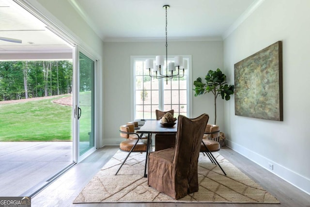 64 Telfair Ct, Acworth, GA 30101 - dining area featuring ornamental molding, baseboards, a notable chandelier, and wood finished floors